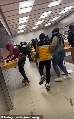 One person can be seen taking an iPhone from the display