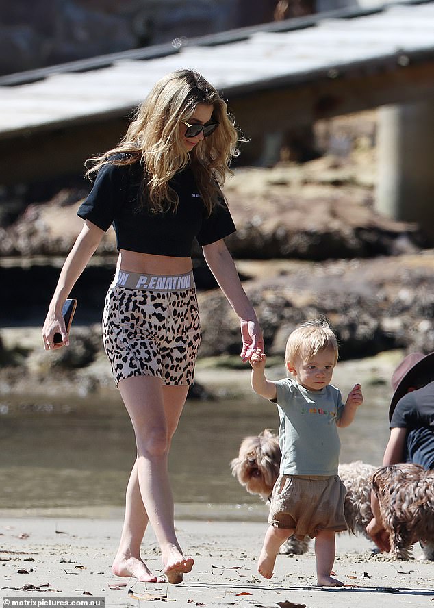 Kyle Sandilands' wife Tegan Kynaston showed off her svelte figure in activewear as she took their son Otto to the beach in Sydney on Friday