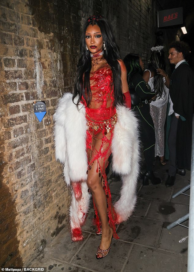 Deadly: Jourdan wore a ripped red dress that showed off her sizzling body as she accessorized with a white feather boa that was dripping with 'blood'