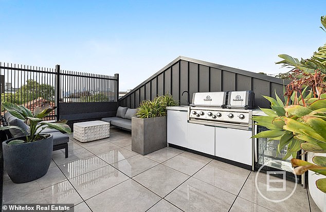 Highlights of the sprawling multi-level luxury apartment include stunning ocean views, high ceilings and beautiful finishes in bronze, marble and American oak.  Pictured: The rooftop entertainment deck and BBQ area