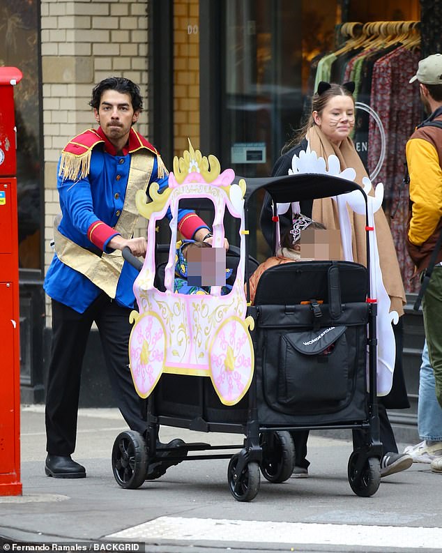 Halloween: The musician was pictured walking through the West Village, New York, dressed as a prince, pushing his children in a princess stroller