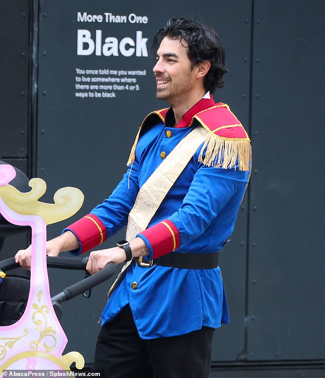 Hilarious: The father-of-two transformed into a prince to push his children into a princess cart