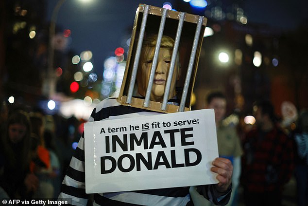 A man dressed as former US President Donald Trump behind bars with a 