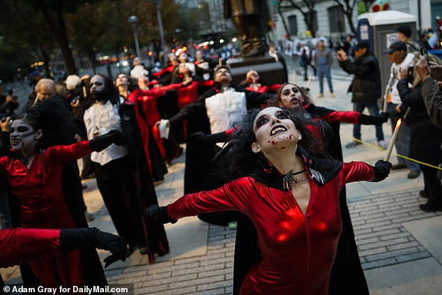 A group of vampire-inspired dancers entertain a crowd on the streets of Manhattan