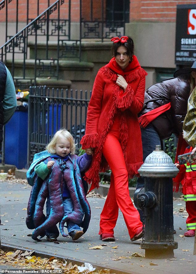 Model Emily Ratajkowski dressed in red devil attire for Trick or Treating with her son Sly before the parade started