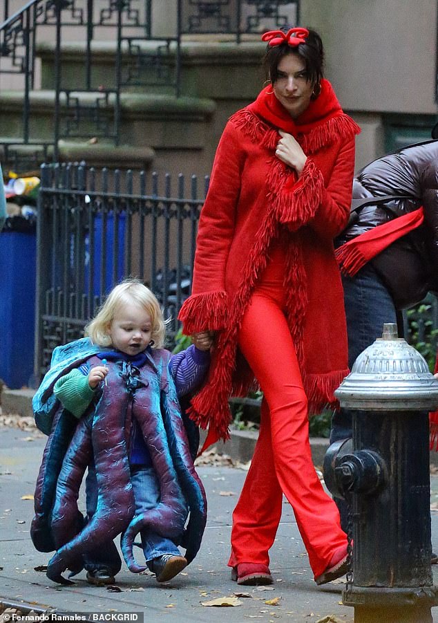 Cute: Emily held the little boy's hand as he happily ate his candy