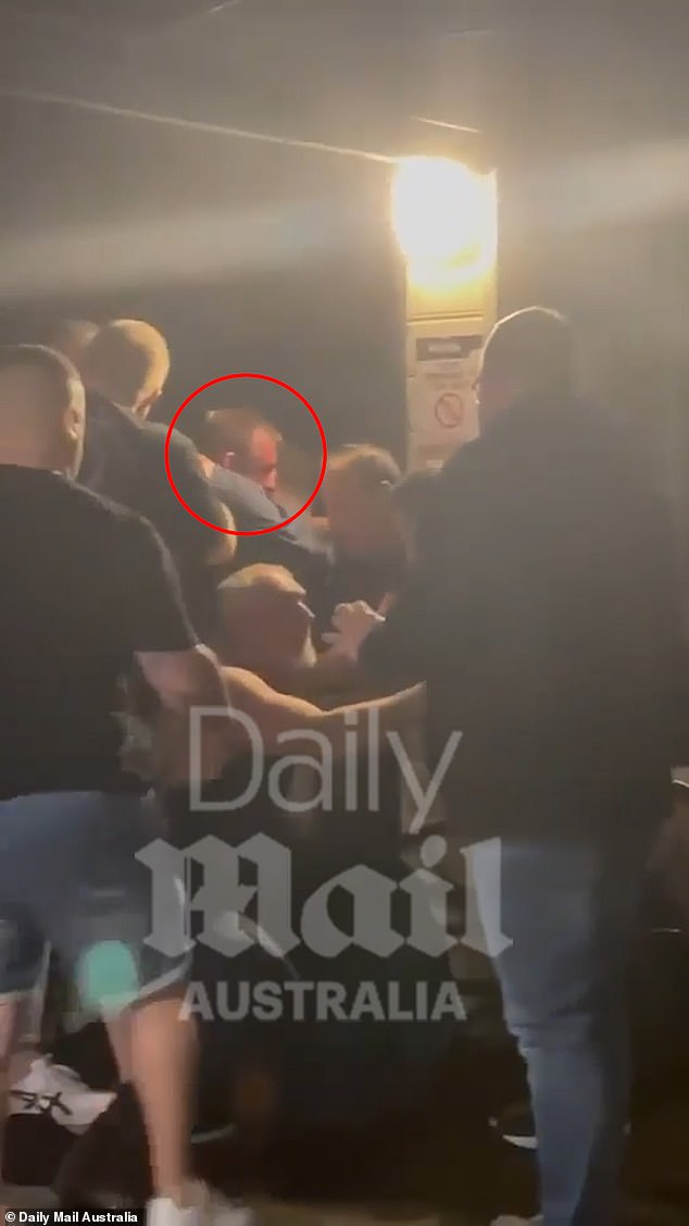 The Nine Network NRL commentator (circled in red) was filmed being restrained by up to four men at the Shoalhaven Heads Hotel on the NSW south coast on Friday evening.