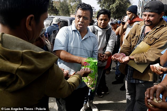 Mujica hands out cookies and crackers in Tijuana in November 2018.  He says the situation now is as bad as he has ever seen