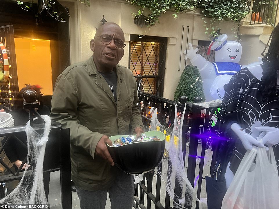 Trick or treating: Al Roker and his wife Deborah Roberts handed out candy on Children's Street in Manhattan