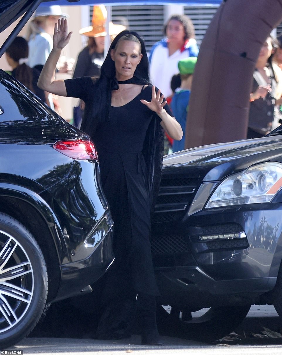 Low profile this year: In Los Angeles, Molly Sims dressed as a witch in an all-black ensemble