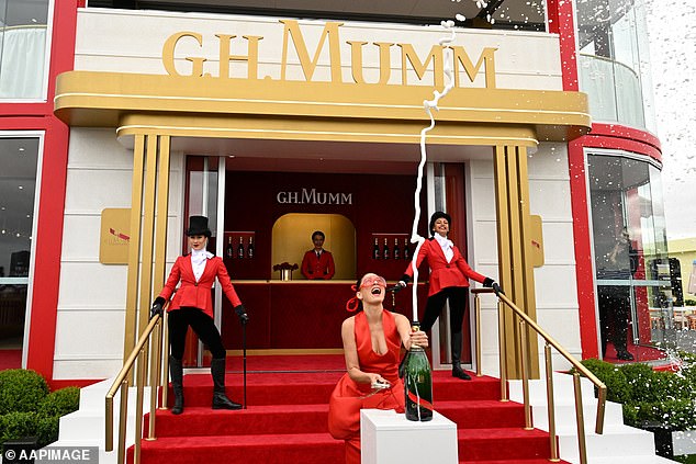 Mumm has transformed a two-story marquee into a Parisian garden.  Pictured is Jess Gomes opening a bottle of champagne