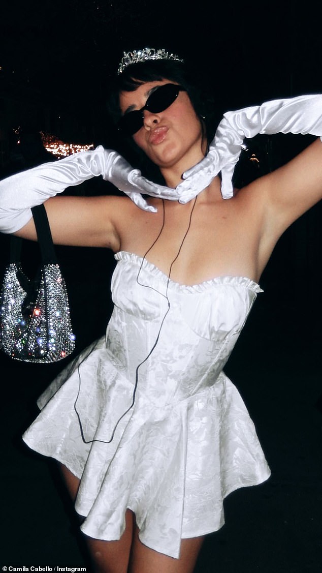 Stunner: Camila added a touch of glamor with white satin gloves that went past her elbows, while she also recreated some of Anne's Princess Diaries looks