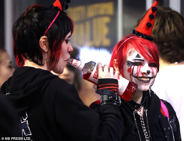 These two partygoers in Leeds couldn't wait to get into the bar for their first drink as they dressed up as clowns