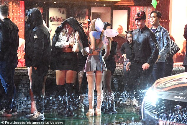 A girl dressed as a fairy embraced the Portsmouth rain showers as she queued outside a nightclub