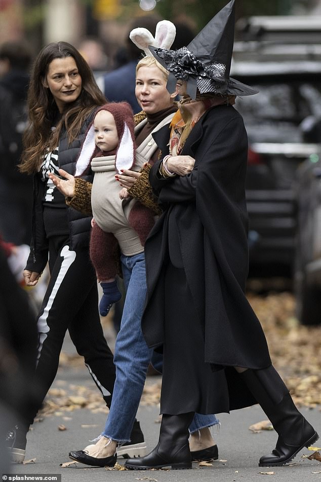 Spooky holiday: The 43-year-old Dawson's Creek alum and her one-year-old baby were joined by her mother Carla Swenson (R), dressed in a witch costume, and a brunette friend (L) in a skeleton top