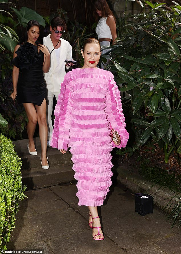 Actress Krew Boylan was also in attendance, wearing a striking bright pink ruffled dress that covered her from the neck to just above her ankles.