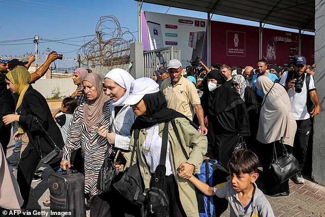 Women smile as they leave the Gaza Strip, which has been under heavy Israeli bombardment for three weeks