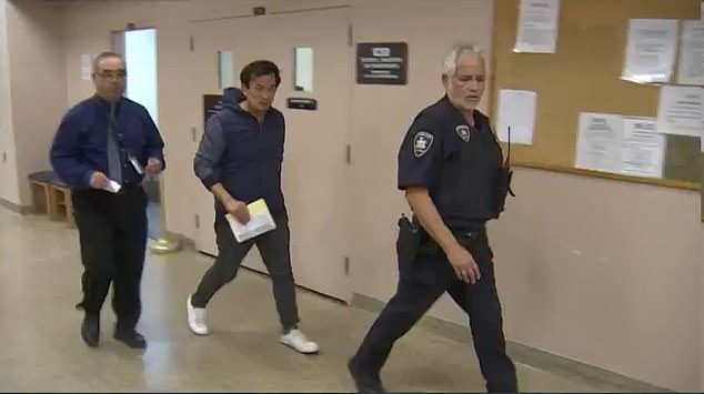 Wen (center) was arraigned in First District Court in Hempstead on Sunday morning and is expected back in court on November 13