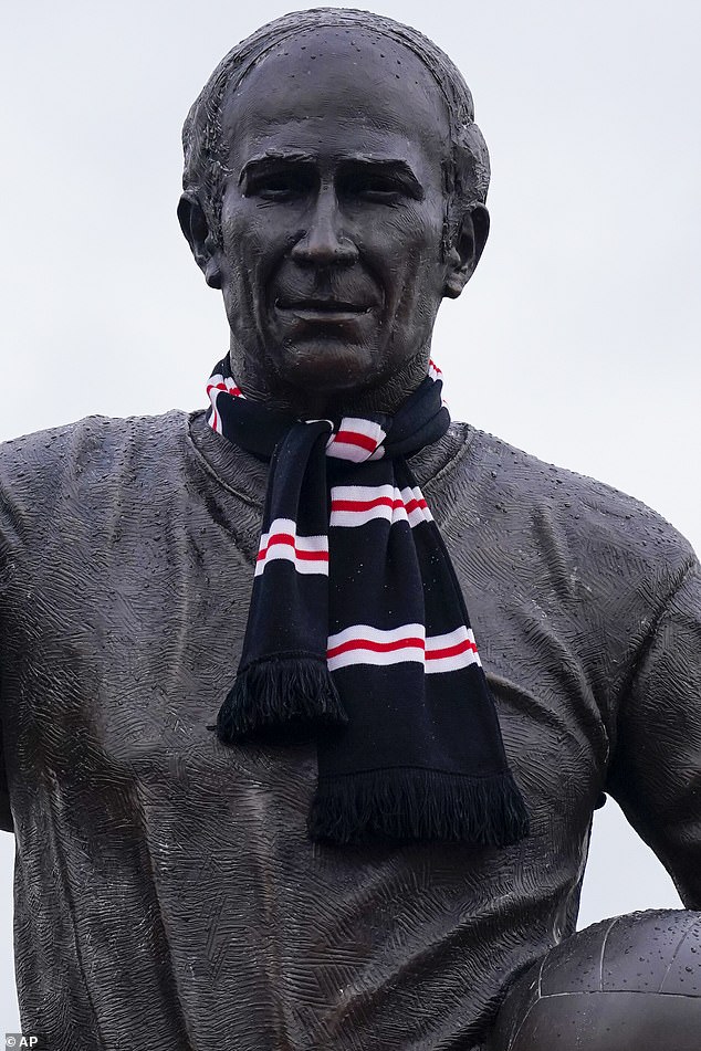 A scarf is wrapped around Sir Bobby Charlton's statue at Old Trafford after his death last month