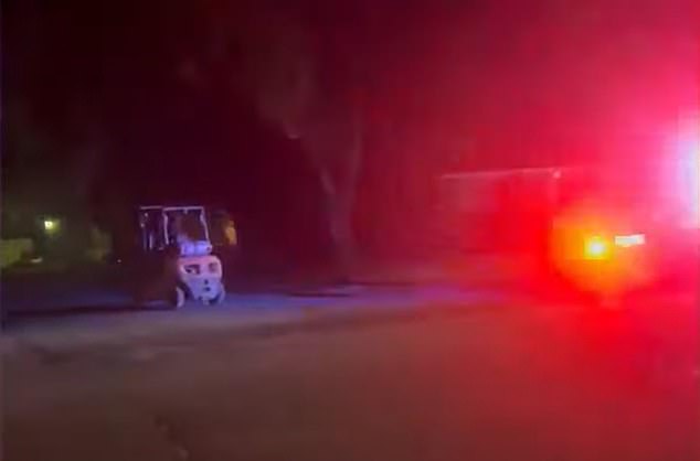 Officers follow the forklift during a nighttime chase.  Witnesses said they were awakened by the sound of sirens as California police followed the vehicle