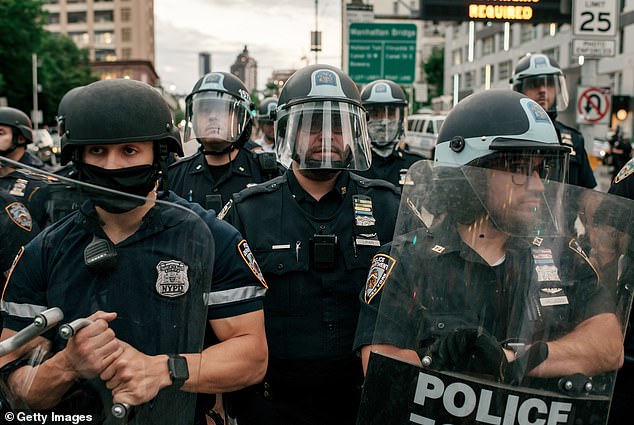 The song made repeated references to BLM protests.  Pictured: NYPD officers block the entrance to the Manhattan Bridge as protests broke out in New York City on June 2, 2020