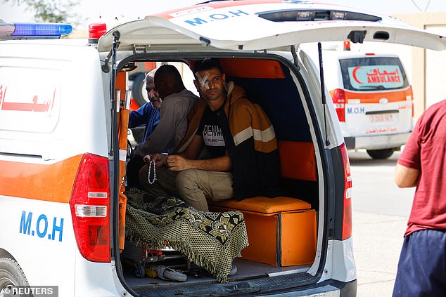 An injured Palestinian man sits in an ambulance as he waits for medical staff to take him to an Egyptian hospital for treatment