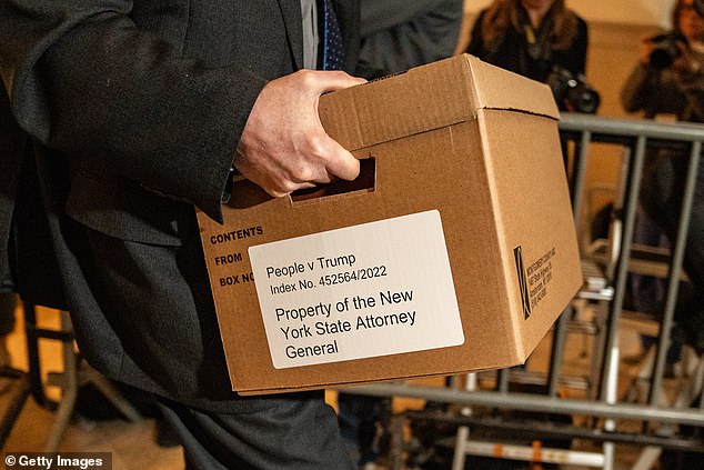 New York attorney general's office staffer carries evidence box as he arrives for Trump Organization civil fraud trial