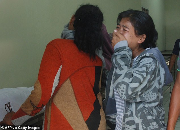 Two women collapse after receiving news that a family member died from drinking illegal alcohol at a hospital in Bandung, West Java province on April 9, 2018 (file image)