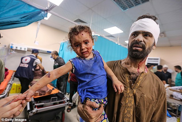 A Palestinian man and a child injured in Israeli airstrikes arrive at the Nasser Medical Hospital in Khan Yunis, Gaza, on Wednesday