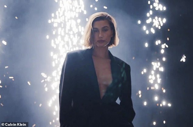 'Hailey Bieber adds holiday sparkle.  Soft and shiny in the relaxed satin blazer and trousers,” Calvin Klein captioned a photo of her rocking her black blazer