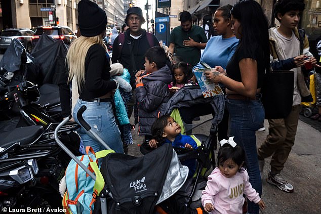 Hundreds of migrants arrive at the Roosevelt Hotel in downtown Manhattan after leaving the controversial St. John's Villa academy shelter on Staten Island.  Staten Island residents protested for weeks against the facility's use as a shelter