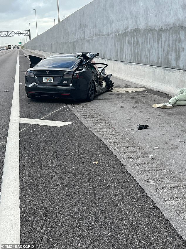 There was significant damage to the front and back of Davis' black Tesla as Davis is seen on the floor