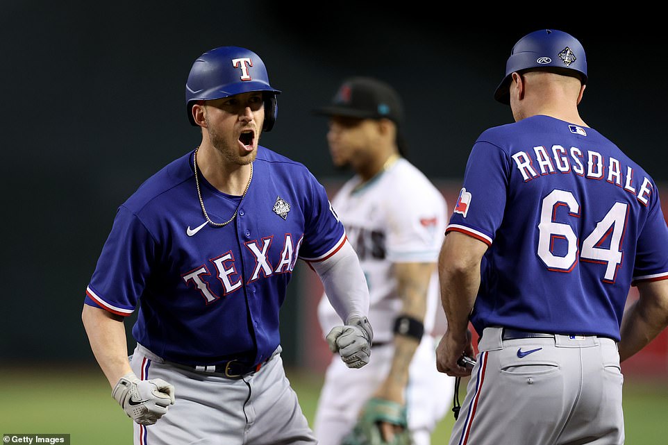 Mitch Garver celebrates at first base after his hit that ultimately led to the winning run in Game 5 of the World Series