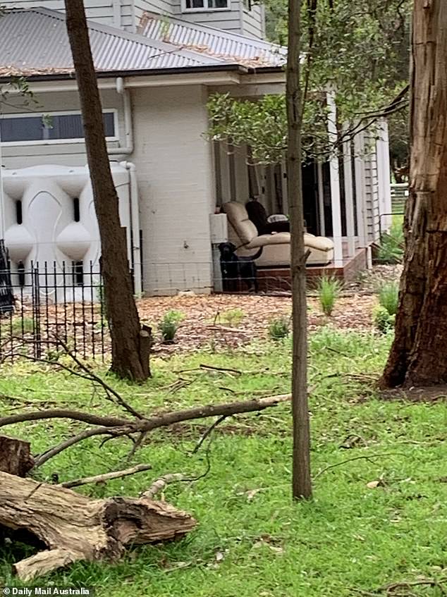 A police dog on the porch of Erin Patterson's home in rural Victoria, which was searched after her arrest