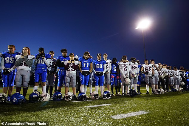 The players from Lewiston High School and Edward Little stand in solidarity and observe a minute of silence