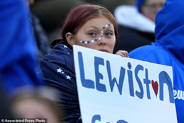 A Lewiston High School fan holds a sign reading 