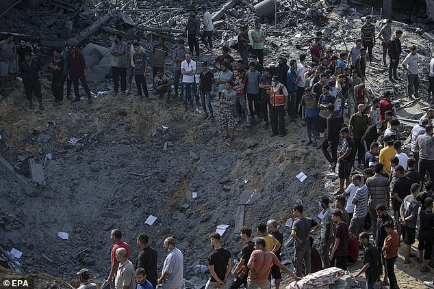 Palestinians search for bodies and survivors among the rubble on Wednesday after Israeli airstrikes on Al Falouja in the city of Jabalia