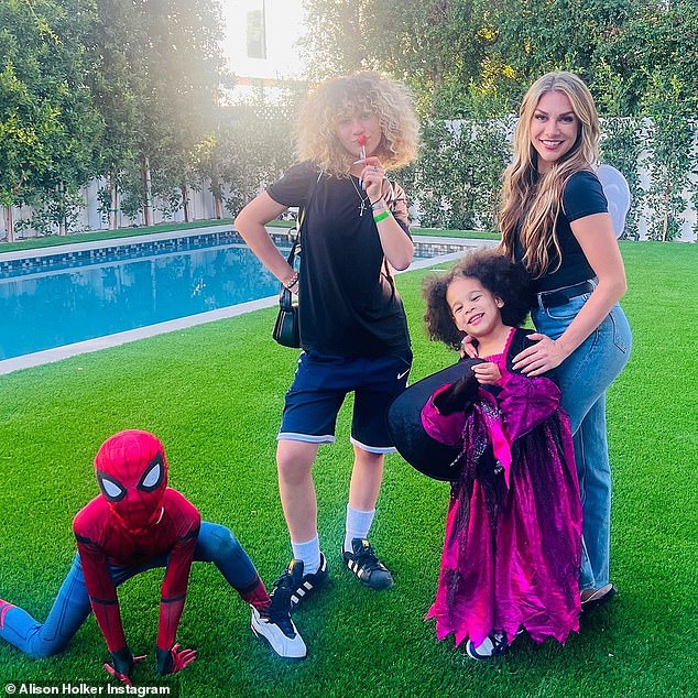 Superhero: Spider-Maddox struck the classic Spider-Man pose as his sisters smiled broadly