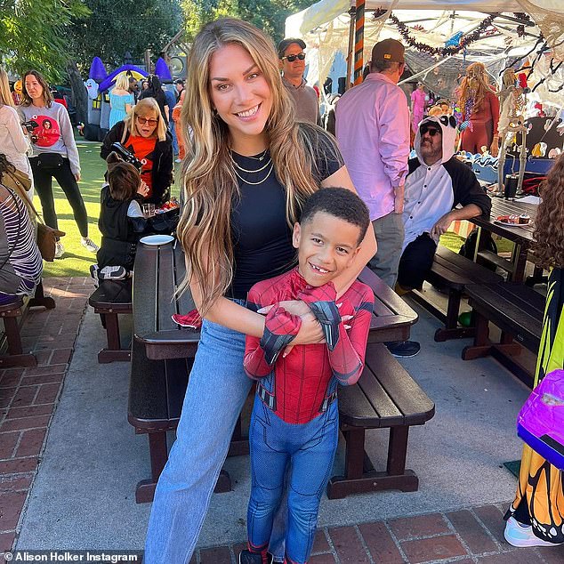 Adorable: Holker also shared a one-on-one photo of herself with her son, showing off the new front teeth he is growing, complimenting his bright smile