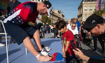 Matt Stutzman signs his cap for a young fan on Paralympic Day in Paris in October