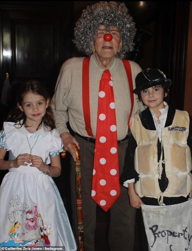 Sweet: Catherine also shared throwback photos of Michael dressing up for Halloween with their son Dylan, 23, and daughter Carys, 20