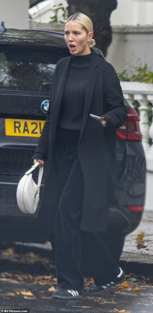 The royal looked chic in a black sweater and pants that she combined with a stylish winter coat