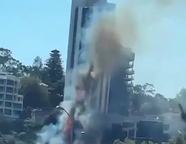 Firefighters were able to fight the fire (above) from the balconies of nearby apartment buildings