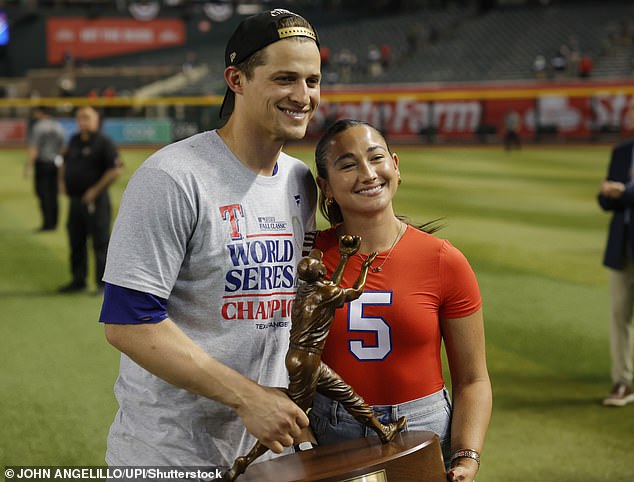 Corey Seager and his wife Madisyn Seager hold the MVP trophy after winning the award