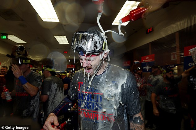 Heim is depicted being doused in beer in the clubhouse after the World Series victory