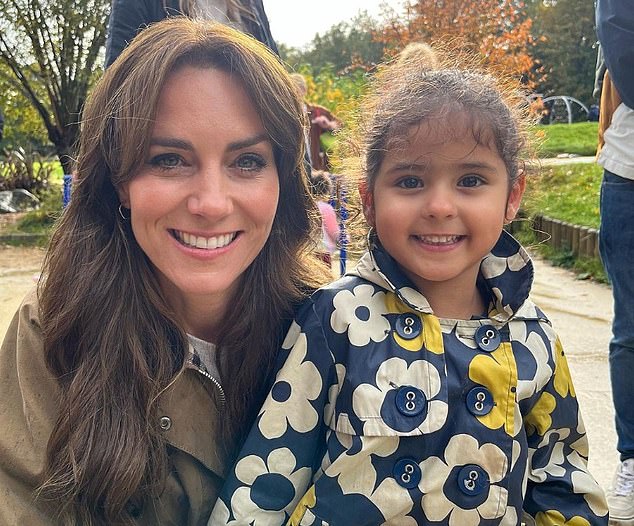 Kate crouched down next to a young girl as her proud father captured the moment on his mobile phone