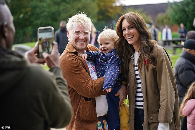 She eagerly posed for photos with some children as she walked through Arnos Grove