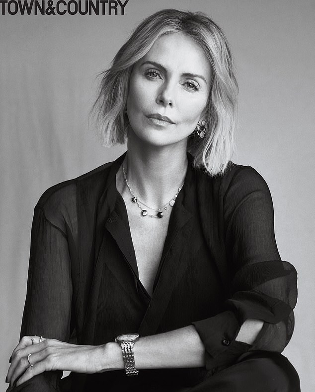 Beautiful: Charlize cut an effortlessly understated figure for the shoot.  On the front, she wore a sheer black Dior blouse, $21,100 Dior earrings and black Nili Lortan pants