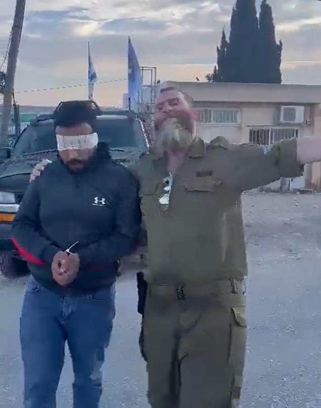 One soldier danced mockingly around the captured civilian while another filmed