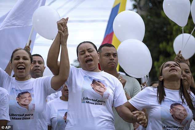 Diaz's mother (center) led a community march Tuesday demanding her husband's release